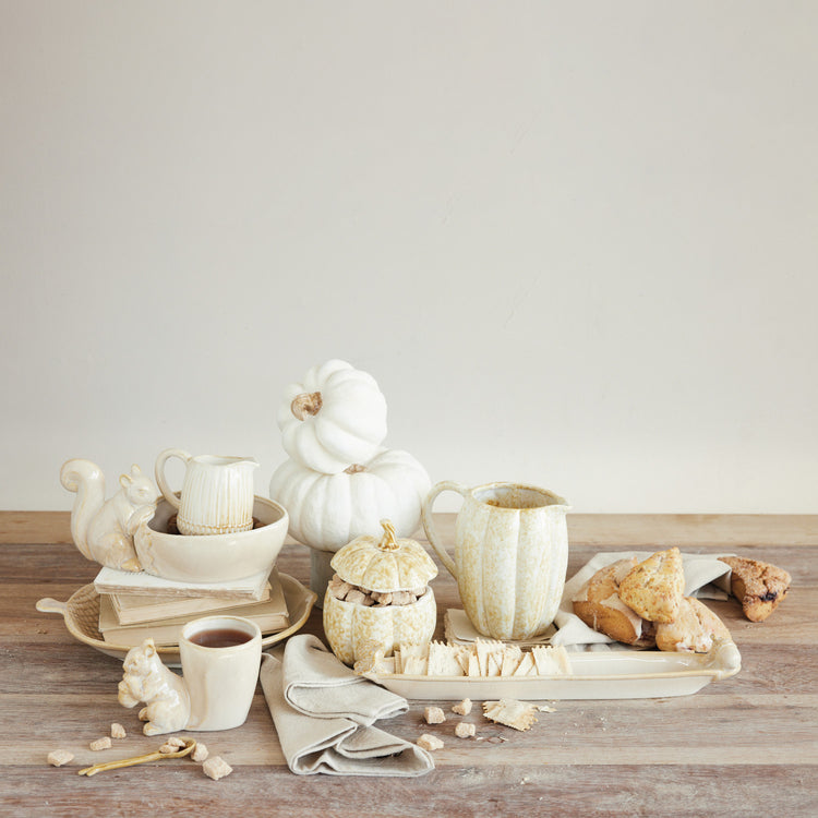 Cream stoneware bowl featuring a small squirrel figurine perched on the rim.