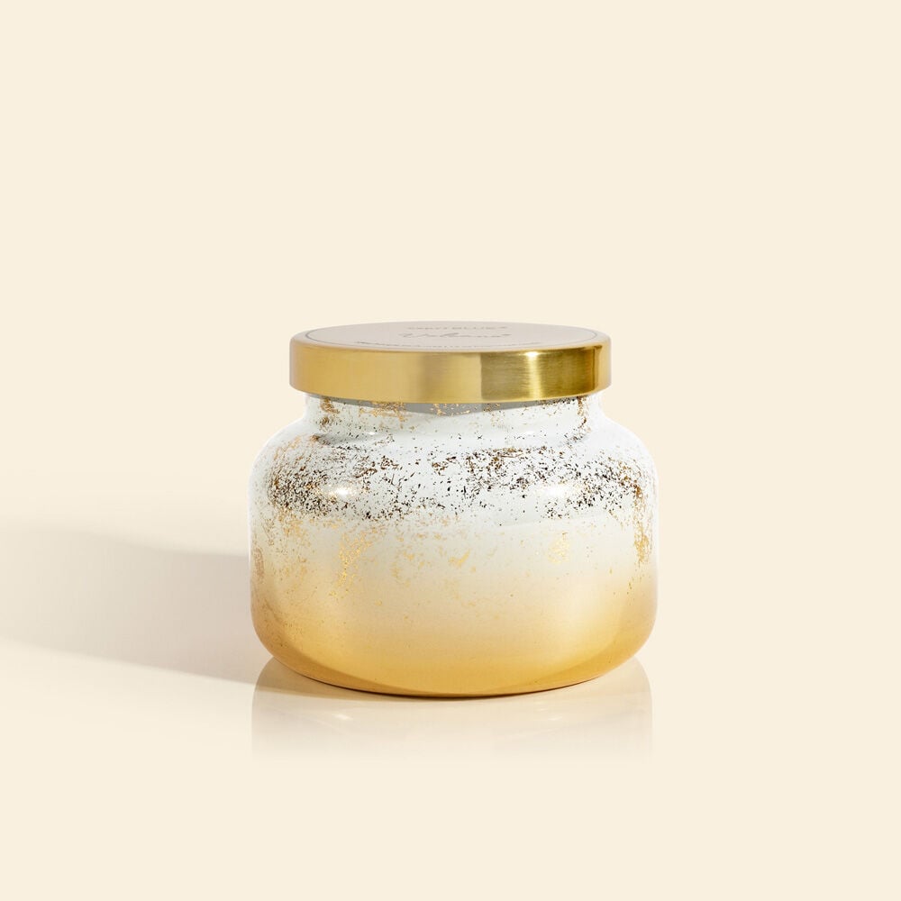 Volcano Glimmer Signature Jar candle in a clear glass jar with black wax and silver glitter swirls.