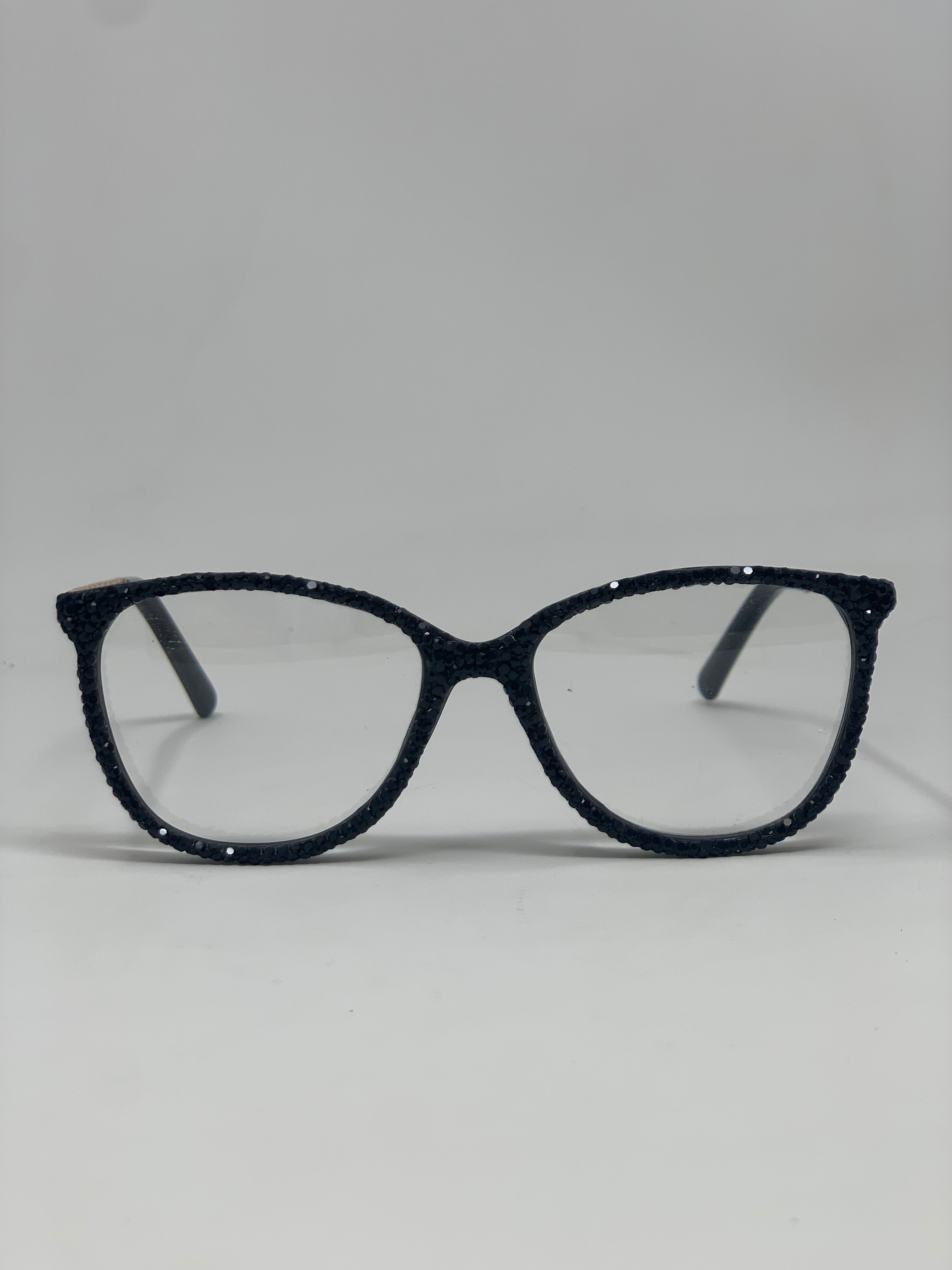 Black cat-eye reading glasses with shimmering rhinestone embellishments on the frames.