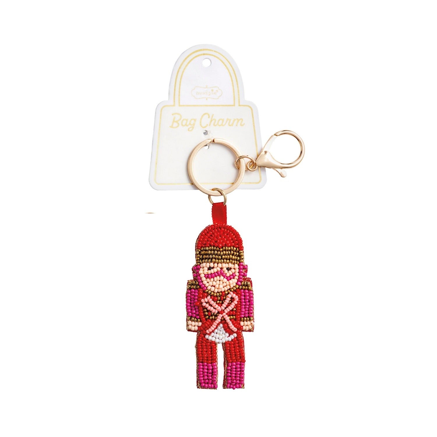 Hand-beaded nutcracker bag charm in red and pink with a gold key ring and lobster clasp.