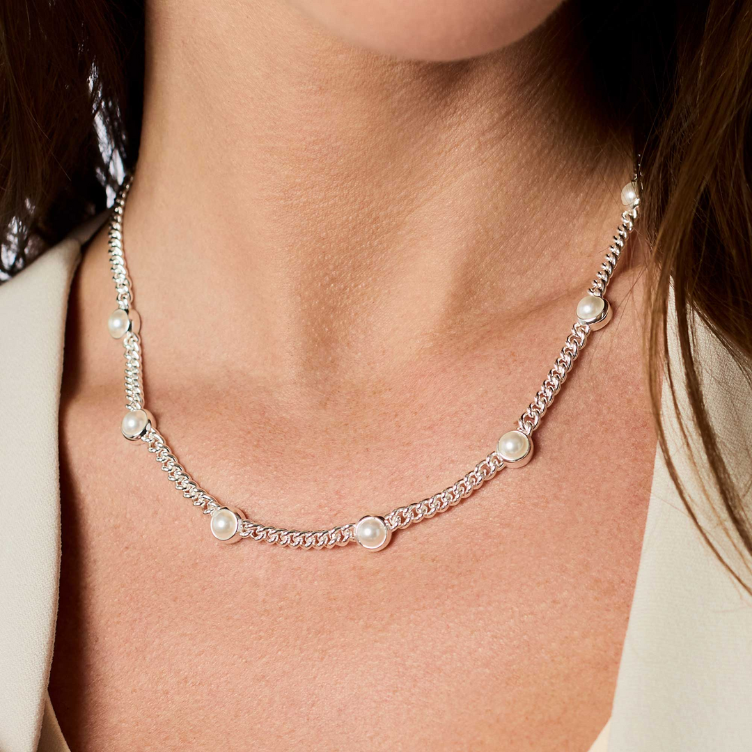 Dolce Delicate Station Necklace in silver with glass pearl accents worn on a model.