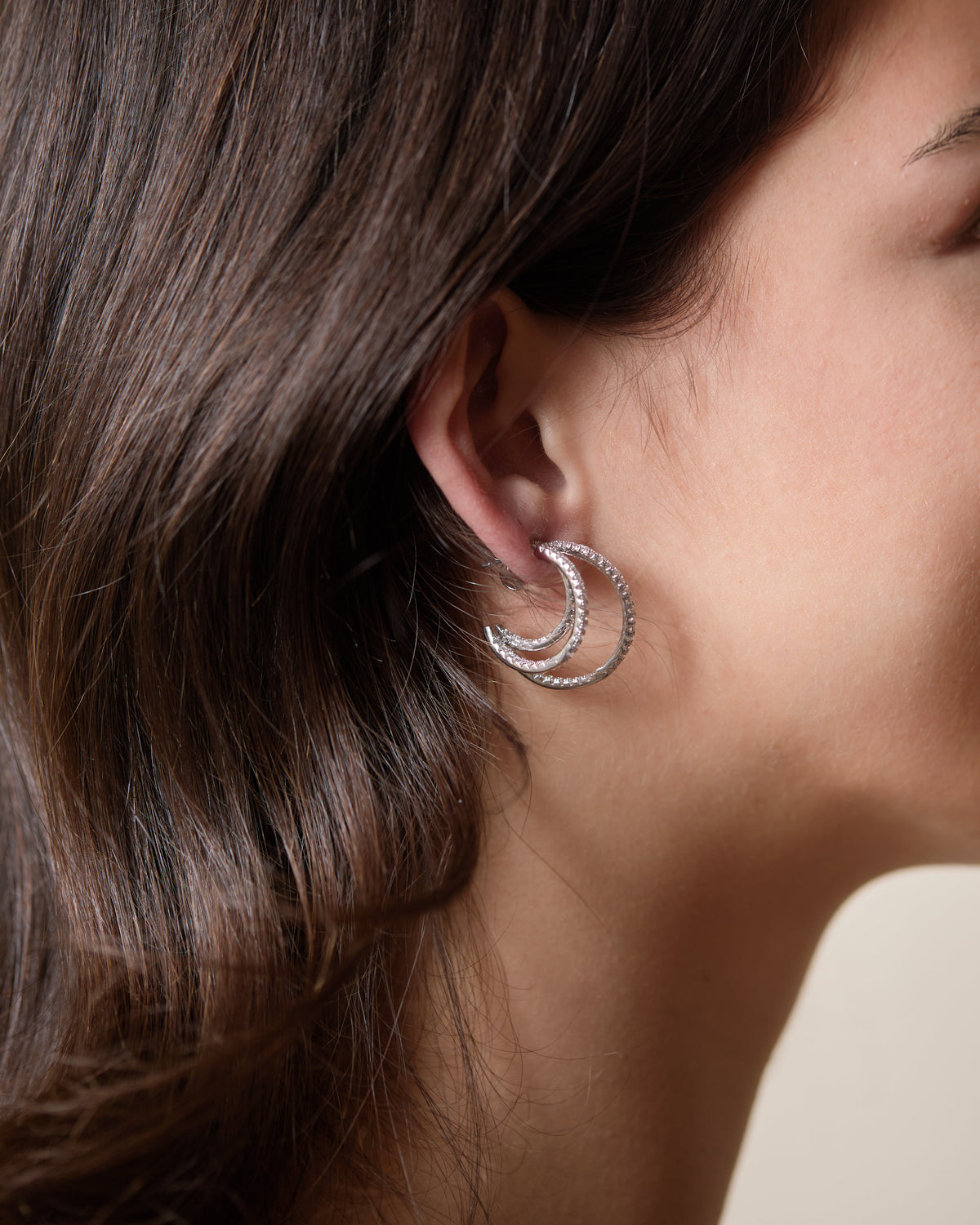 Maeve Triple Hoop earrings in polished gold metal with three concentric circular hoops.