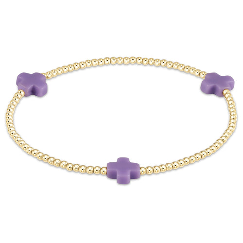 Small gold-filled bracelet with a signature cross bead pattern on elastic cord
