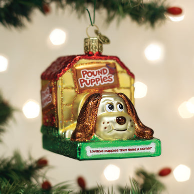 Pound Puppies glass ornament featuring a puppy in a yellow doghouse with a red roof.