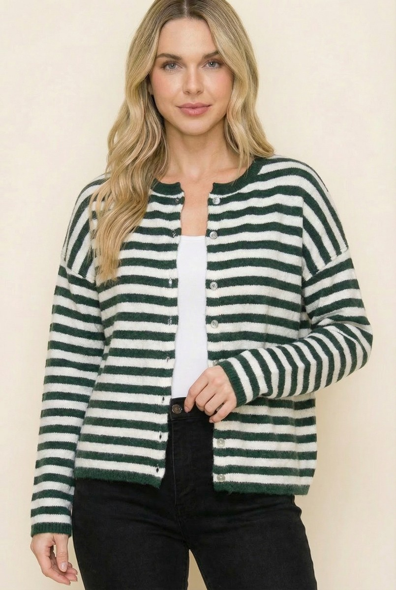 Woman wearing a green and white striped button-down cardigan over a white top and black jeans.