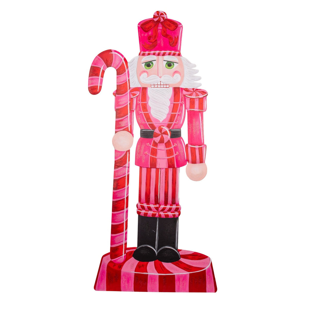 Pink Nutcracker figurine with gold accents on a black stand.