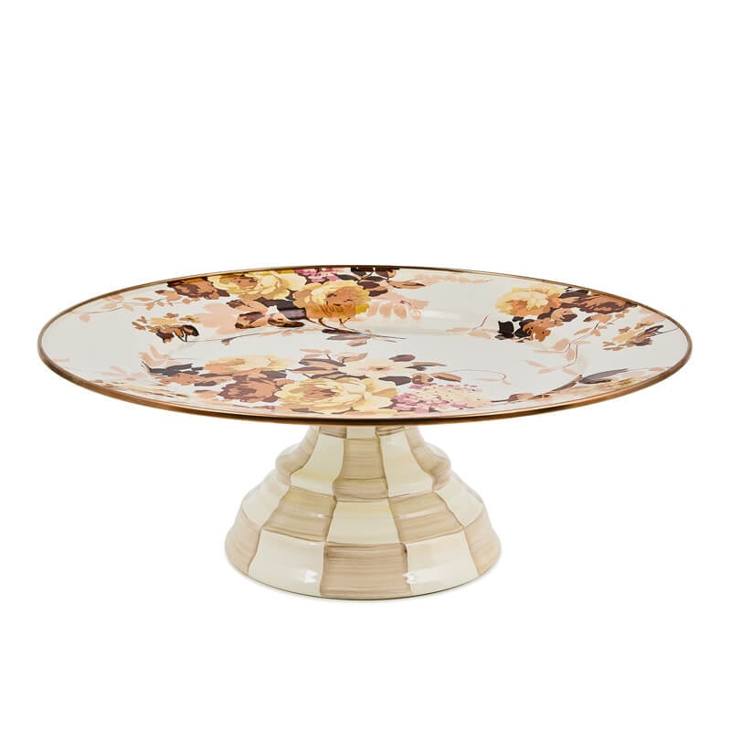 Large white pedestal platter with a wild rose floral pattern and a checkered base.
