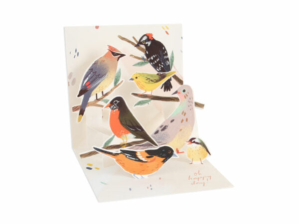 White envelope with gold foil text reading 'oh happy day!' inside a colorful bird illustration.