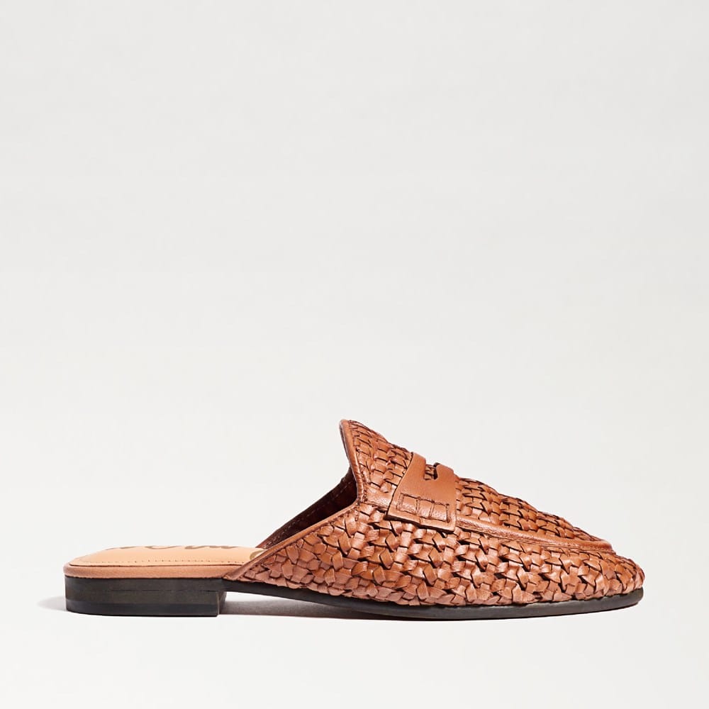 Side view of a brown Tullie Woven Mule with an almond toe and flat heel.