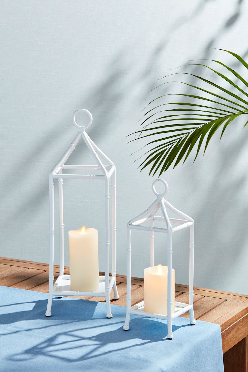 White bamboo lantern with metal frame in a cylindrical shape.