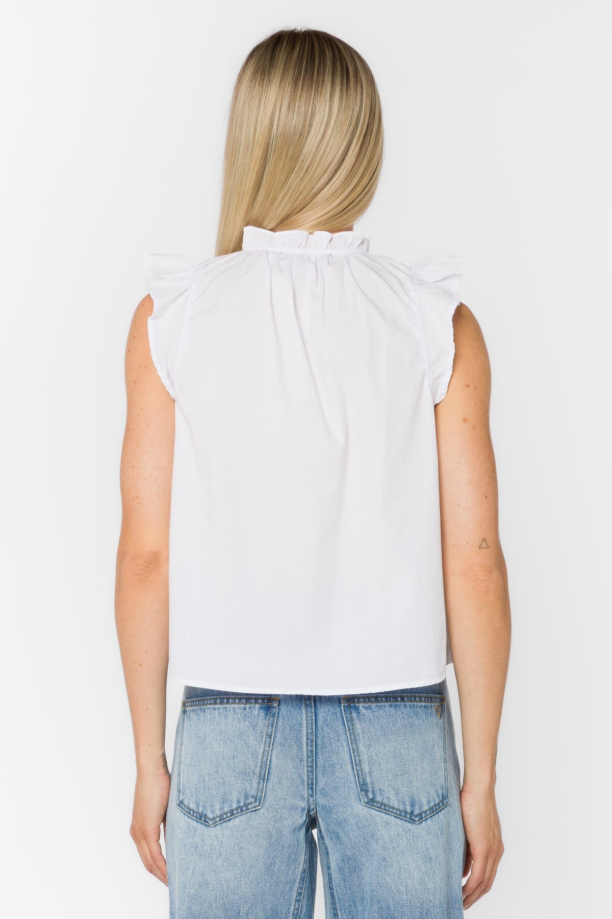 Black poplin sleeveless top with Mandarin collar, V-neckline, tie detail, and ruffle edge.