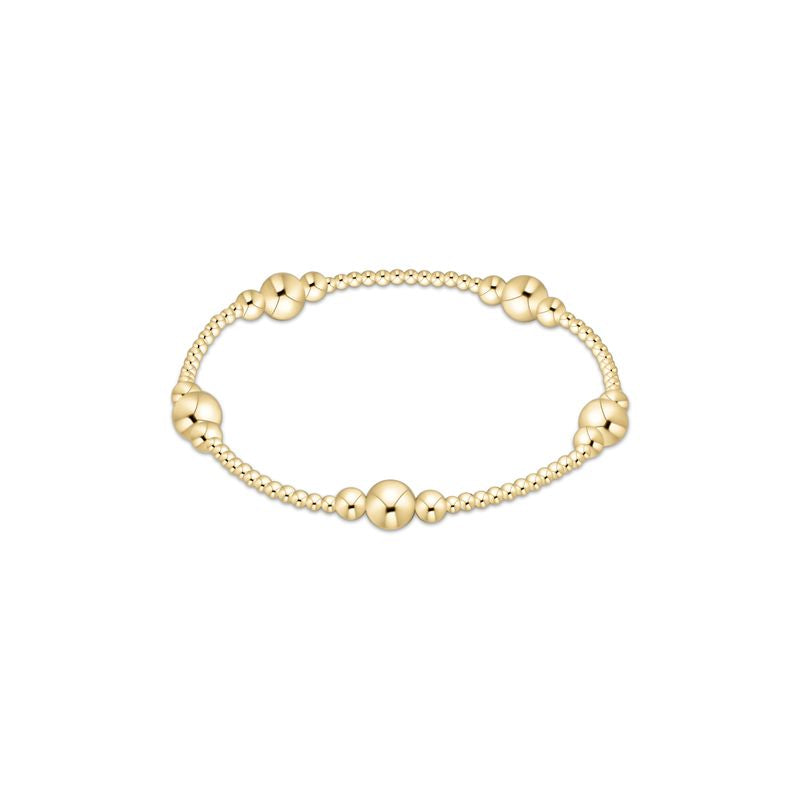 Polished gold-tone bead bracelet with a sleek stacked silhouette.