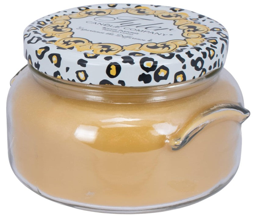 A large black glass jar candle with a white wick.