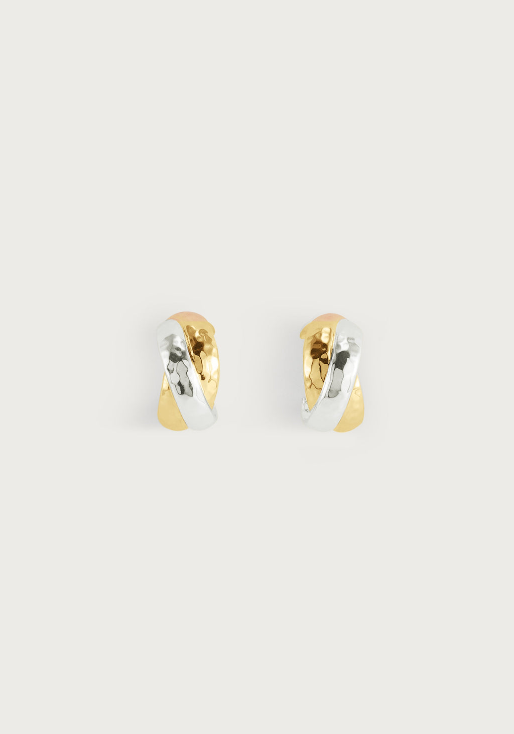 Farrier Triple Huggie Hoop Earrings featuring interlocking hammered gold and silver bands.