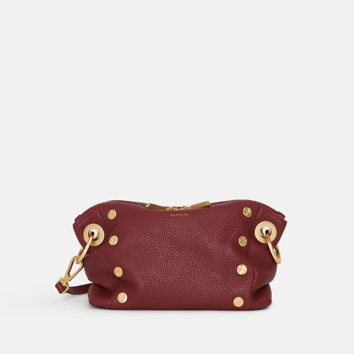 Black pebbled leather Daniel crossbody clutch with red suede lining, gold hardware, and a removable strap.