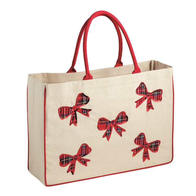 Cream canvas tote bag with red handles and five red plaid sequin bow appliqués.
