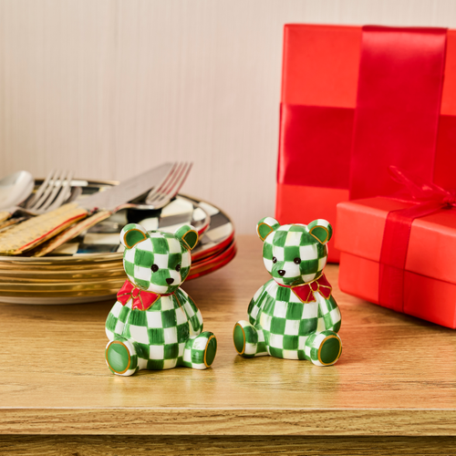 Emerald Check Holiday Bear Salt & Pepper Set on a wooden table next to plates and red gift boxes.