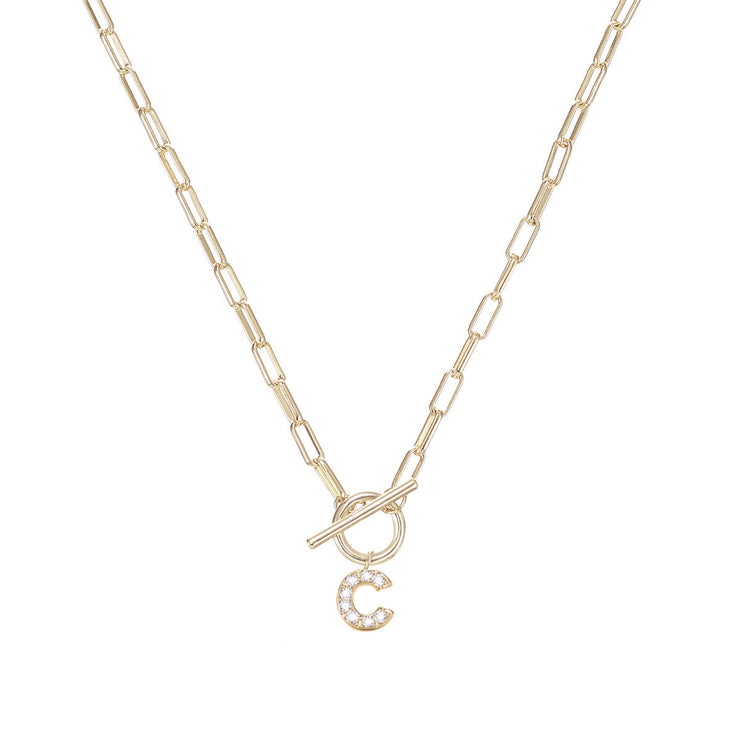 Gold paperclip chain necklace with a toggle closure and a sparkling crystal-encrusted letter C.