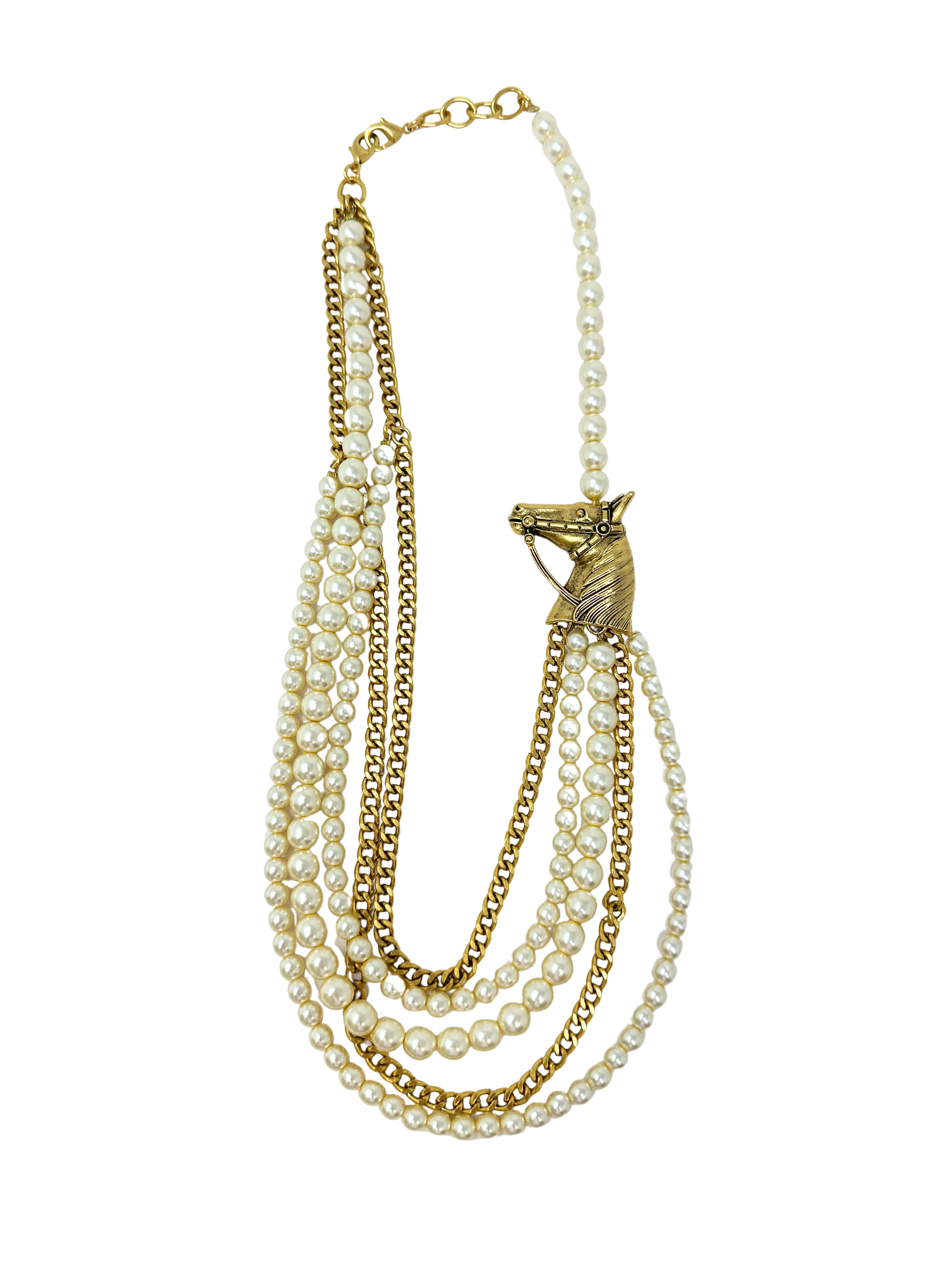Multi-strand necklace with white pearls, gold chains, and a gold horse head charm.