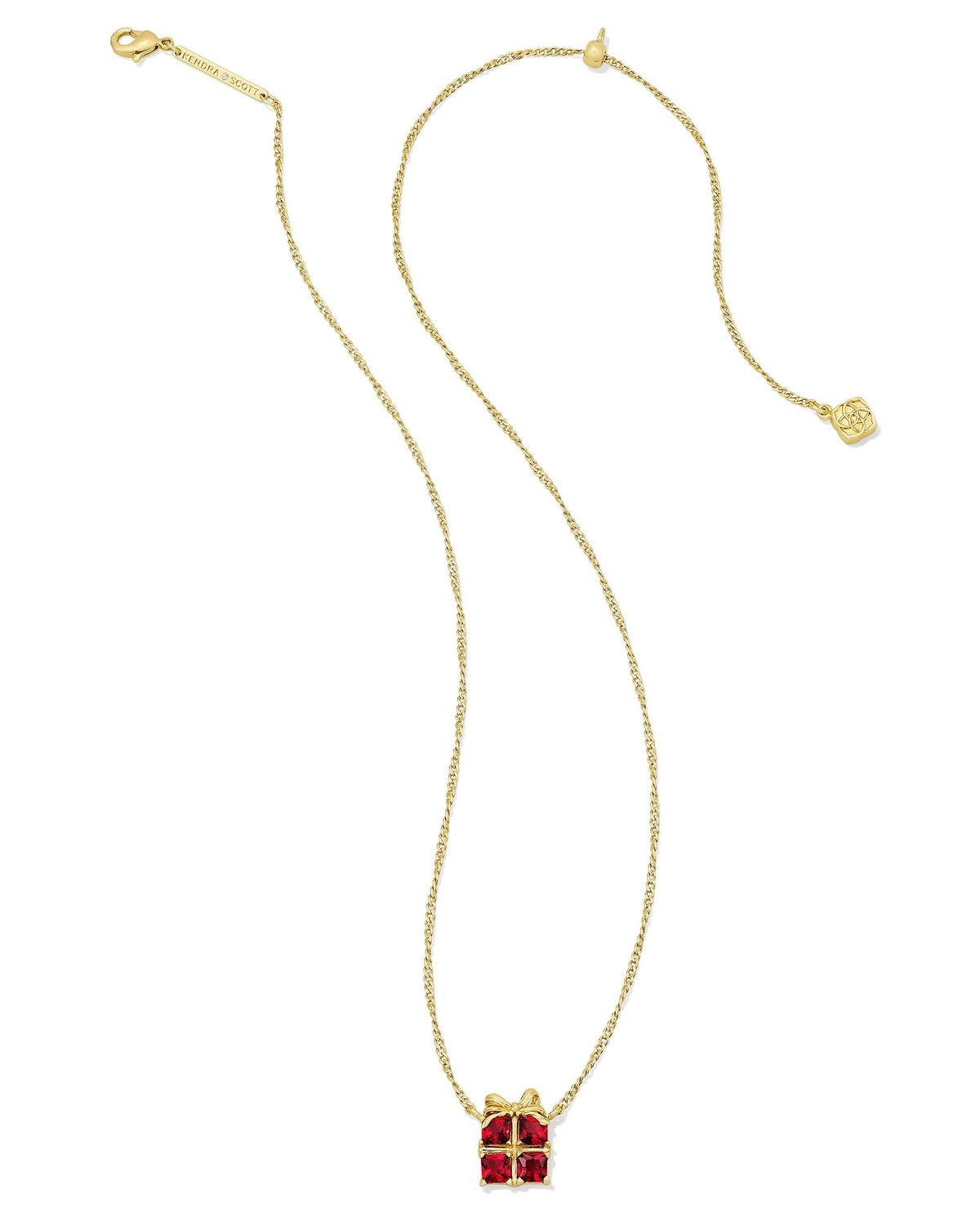 Gold short pendant necklace featuring a red crystal present-shaped charm with a gold bow.