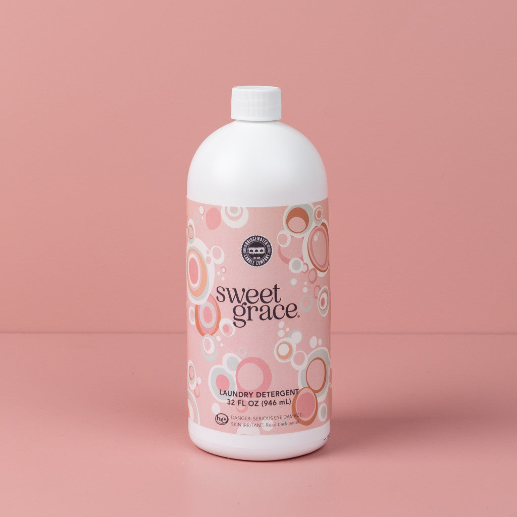32oz bottle of Sweet Grace laundry detergent with a pink bubble pattern on a pink background.