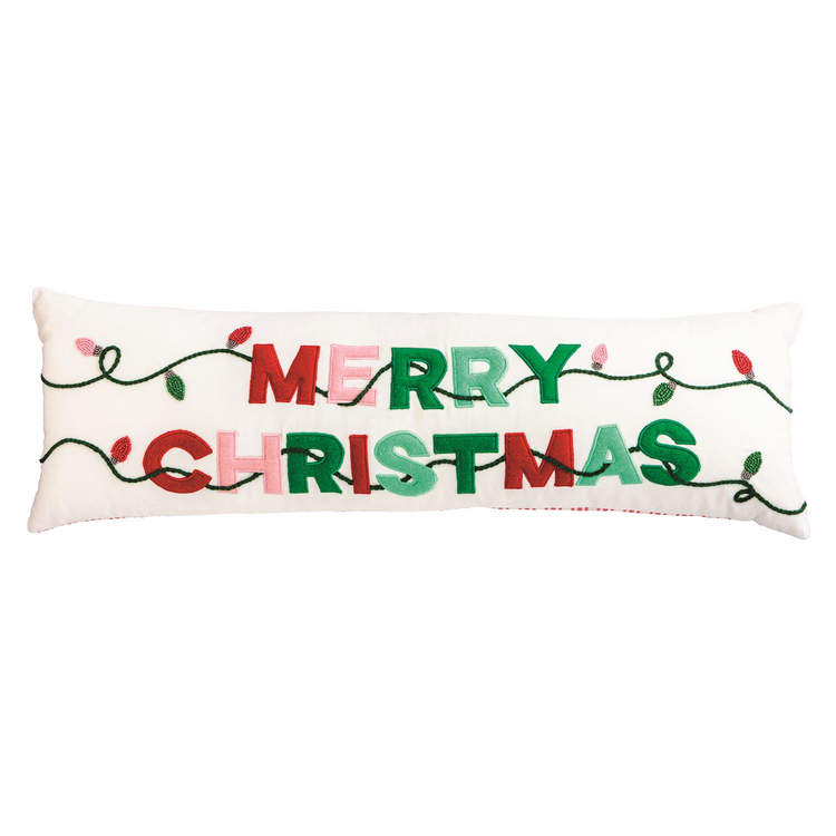 White lumbar pillow with embroidered 'Merry Christmas' text and colorful holiday light string.