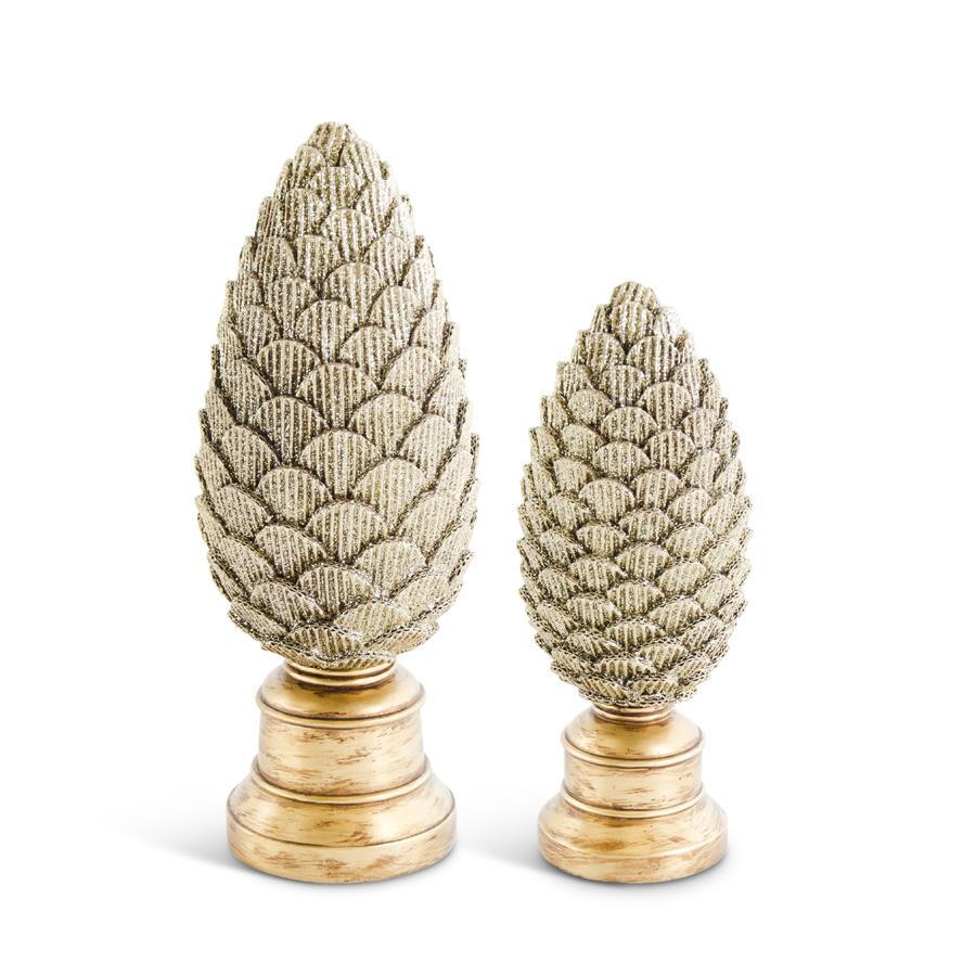 Two scalloped gold glittered resin pinecones on pedestals in small and large sizes.
