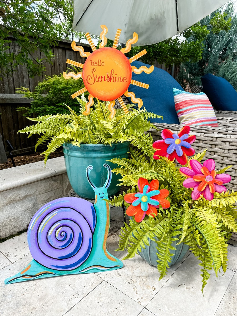 Enchanted Flowers Small decorative stake with a floral silhouette in soft pastel tones.