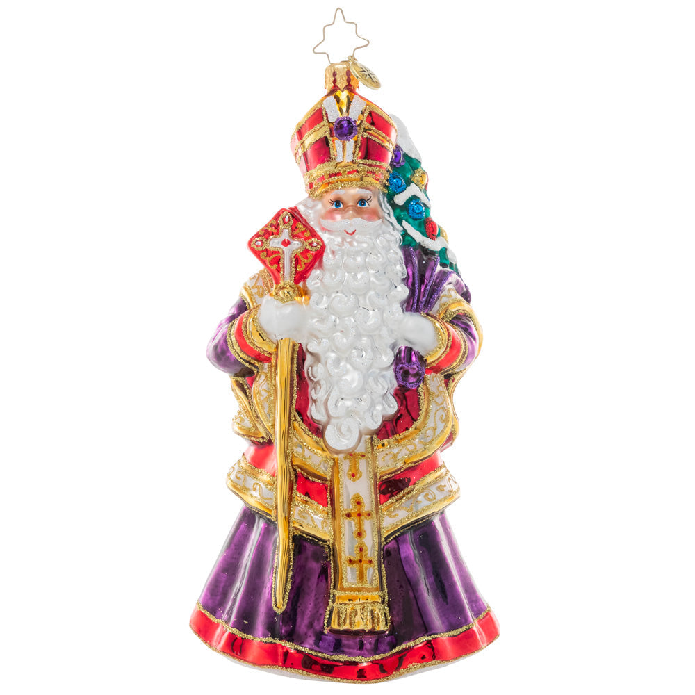 Patron Saint of Christmas ceramic figurine with a red robe, gold halo, and green wreath details.