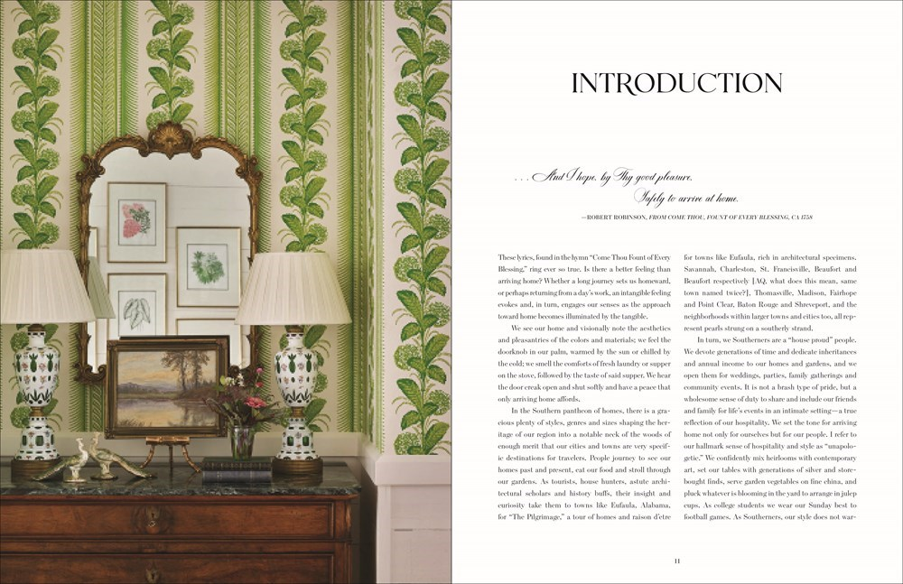 Open book 'Arriving Home' showing an interior design introduction with green patterned wallpaper.