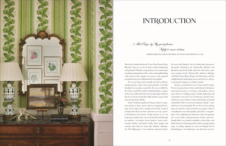 Open book 'Arriving Home' showing an interior design introduction with green patterned wallpaper.