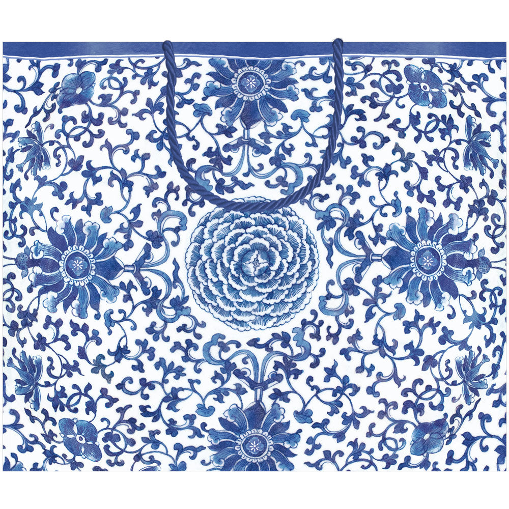 Large horizontal indigo blue gift bag with white handles featuring a subtle garden pattern.