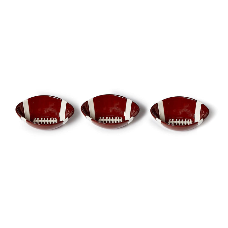 Three football-shaped ceramic tidbit bowls in dark red with white laces and stripes.