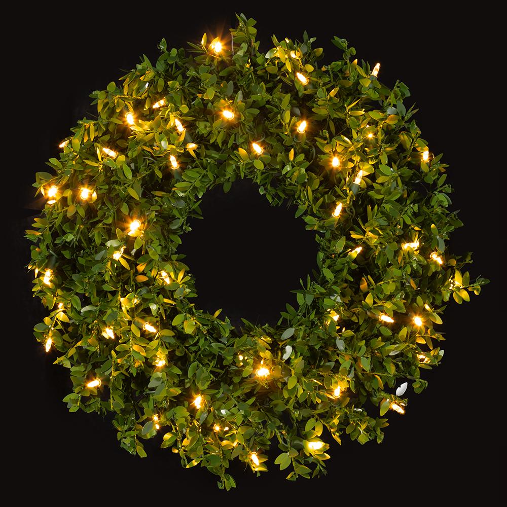 24-inch green PVC mini leaf wreath with 50 glowing warm white LED lights against a black background.