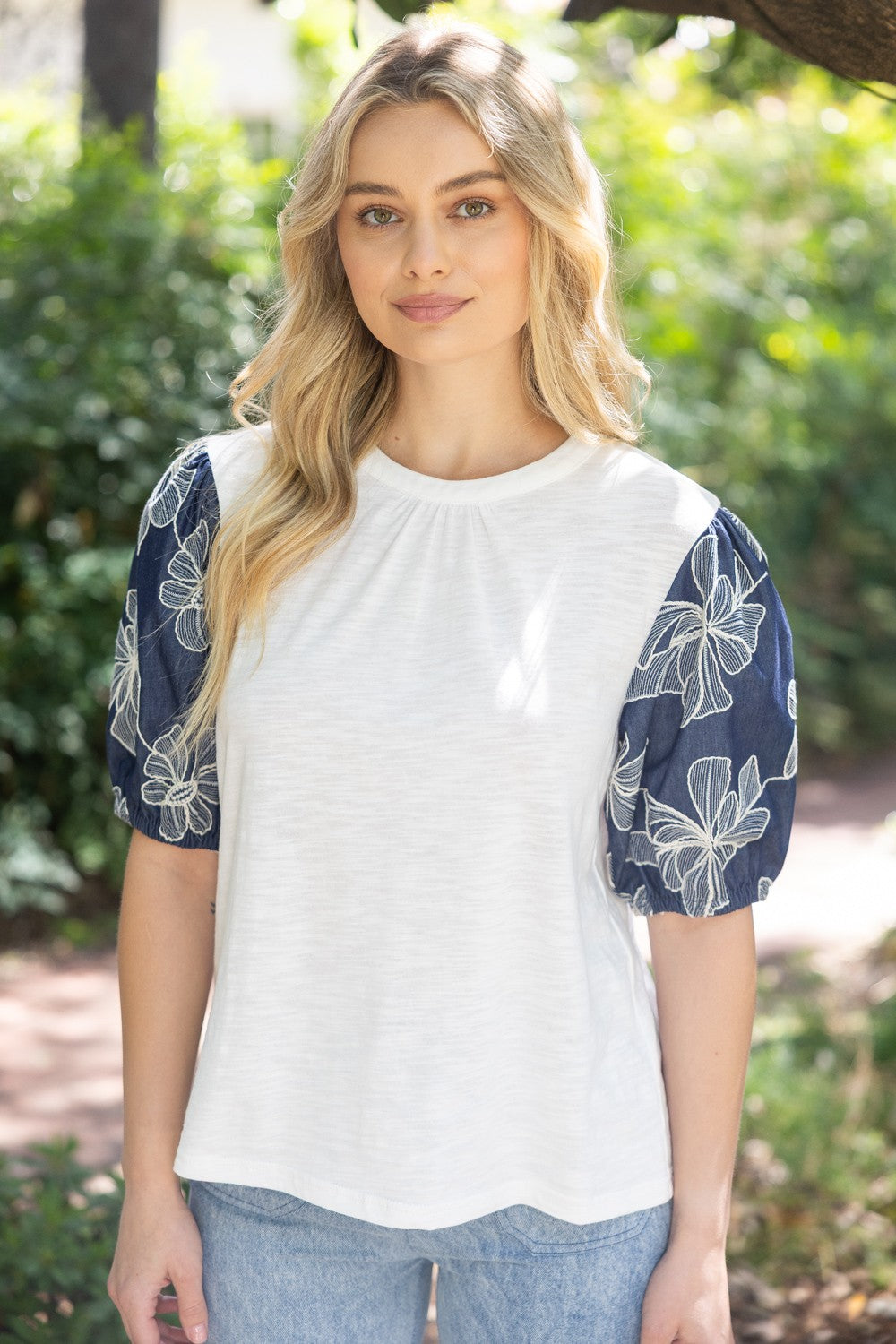 Floral embroidered puff sleeve slub knit top in soft neutral tone with feminine silhouette.