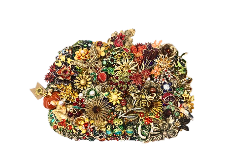 Intricate pumpkin-shaped wall art made of colorful vintage-style jewelry, brooches, and beads.