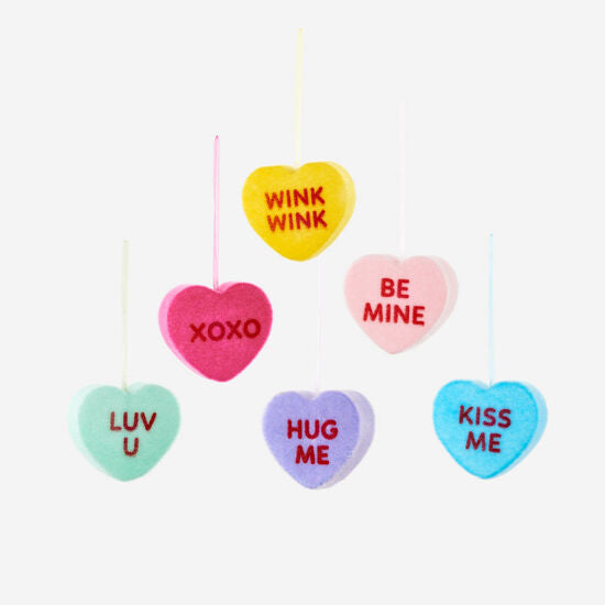 PVC flocked conversation heart candy in pastel pink with white polka dots.