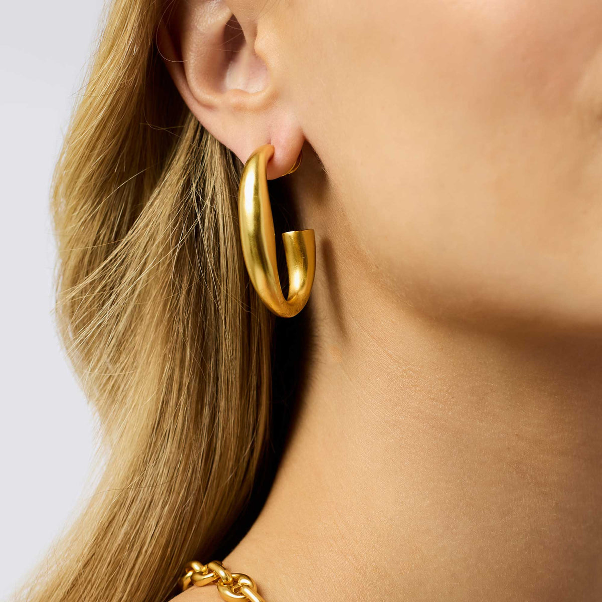 Laguna Hoop earrings in polished gold finish with smooth circular hoop silhouette.