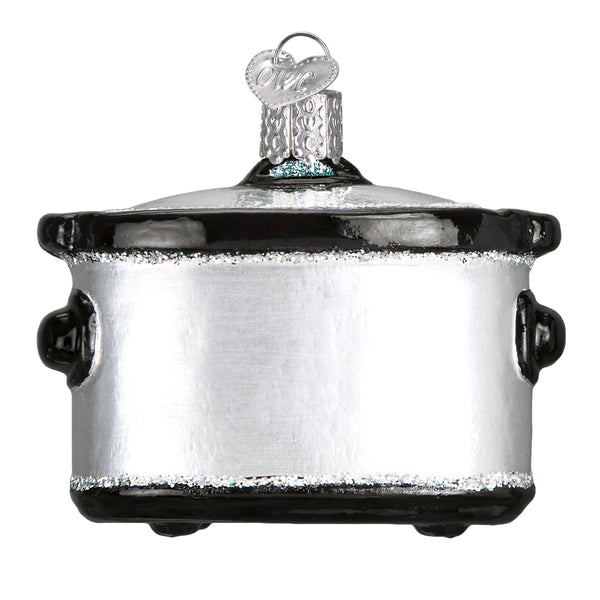 Silver and black glass slow cooker Christmas ornament with glitter accents and a heart-shaped tag.