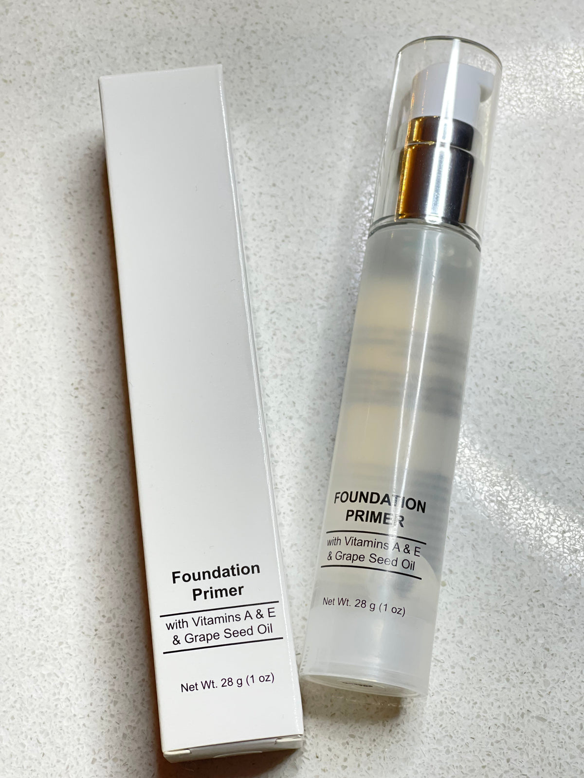 Foundation Primer bottle with pump and box, both labeled with "Foundation Primer with Vitamins A & E & Grape Seed Oil, Net Wt. 28 g (1 oz)".