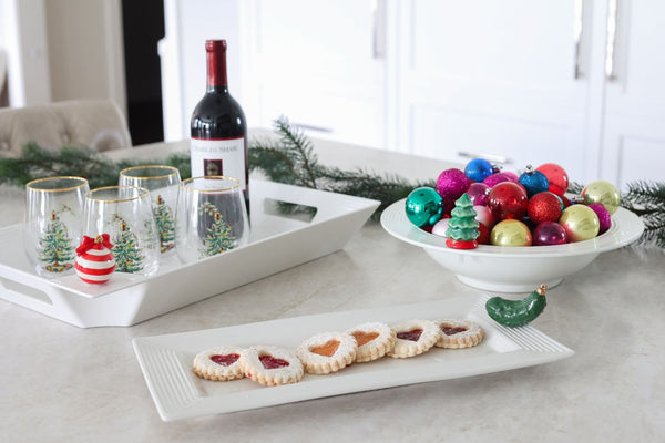 White rectangular ceramic bread tray with a striped texture on the edges, holding heart-shaped jam cookies.