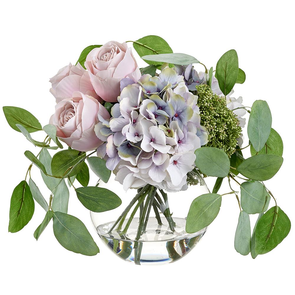 Glass vase holding pink rose, lavender hydrangea, and sedum with polyester floral arrangement.
