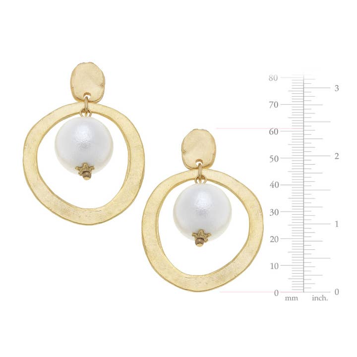 Gold hoop earrings with a textured finish and a white cotton pearl drop, shown with a size scale.