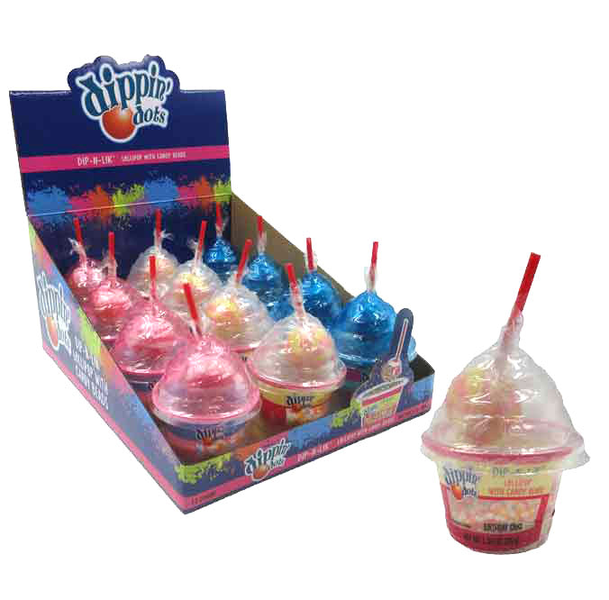 Dippin Dots Dip-N-Lik candy with a red straw in a clear cup, with a box of similar candies in the background.