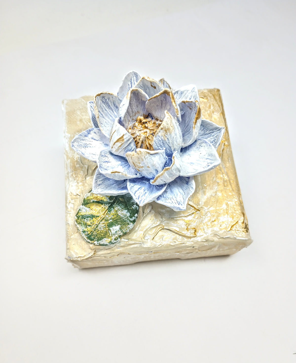4x4 inch clay waterlily artwork sculpture in earthy tones with organic petal shape.