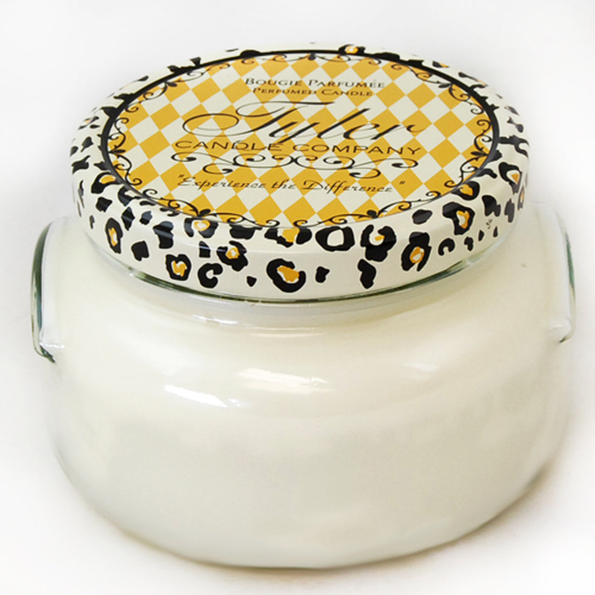 A large glass jar candle with a white wax surface inside.
