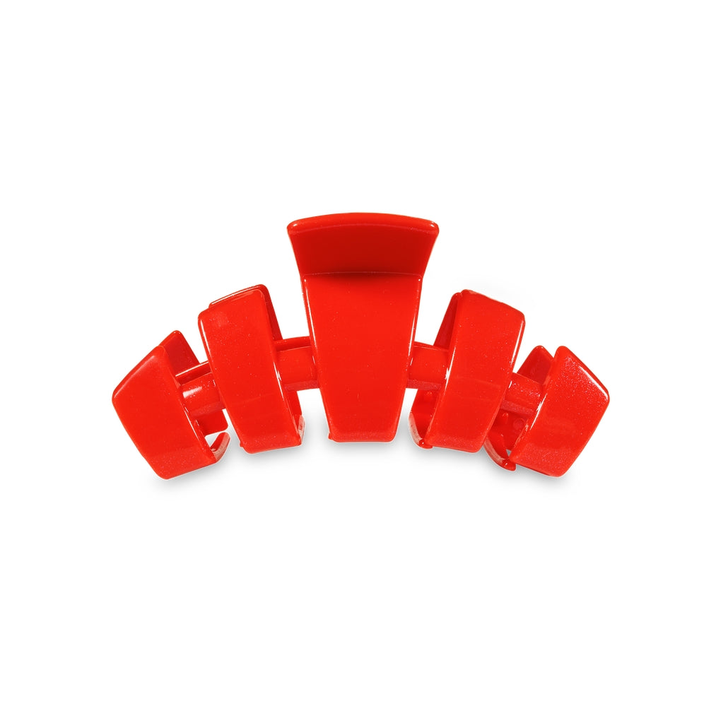 Small red classic hair clip with a curved design and five teeth on a white background.