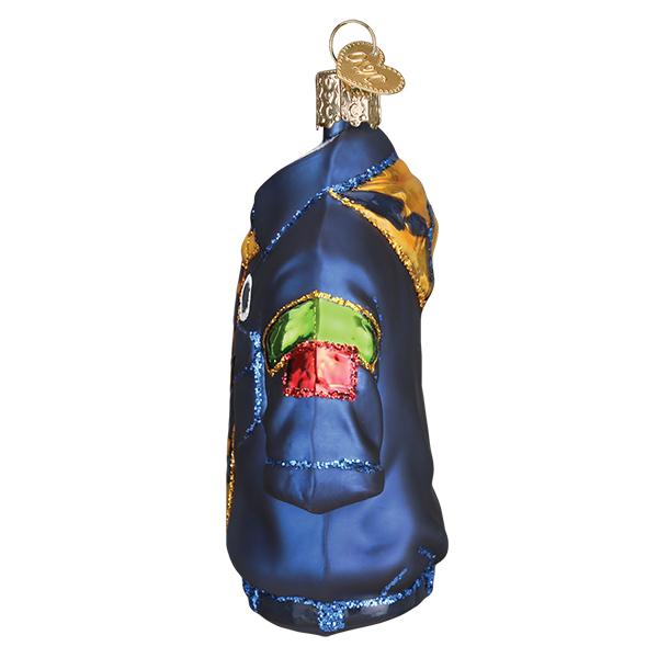 Side view of a blue glass Scout Uniform Christmas ornament with colorful patches and glitter trim.