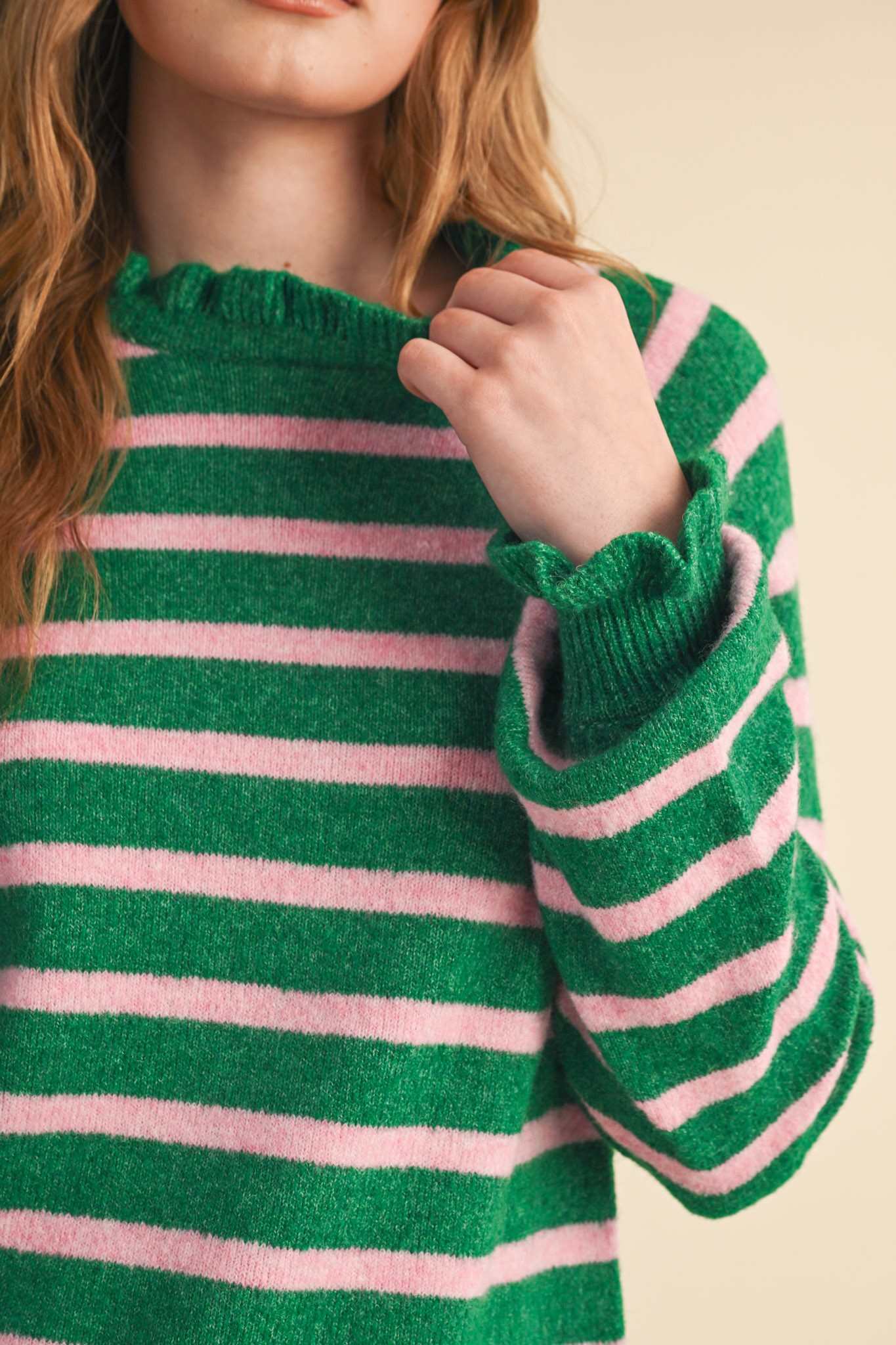 Close-up of the green and pink striped Charlie Ruffled Striped Sweater with ruffled neck and cuffs.