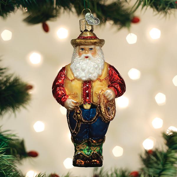 Western Santa glass ornament with a cowboy hat, red shirt, yellow vest, blue jeans, and a lasso.